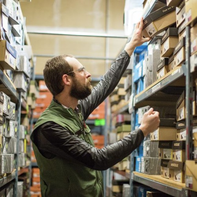 REI employee stocking shelves