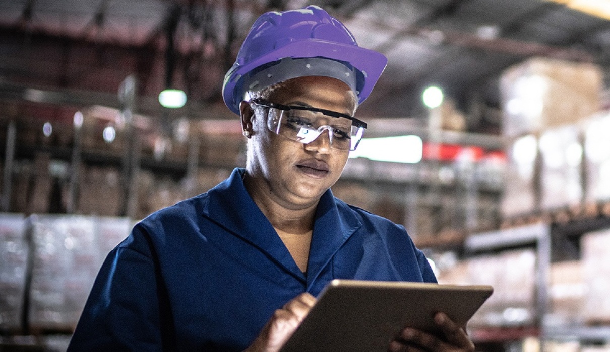 Person in hardhat on tablet