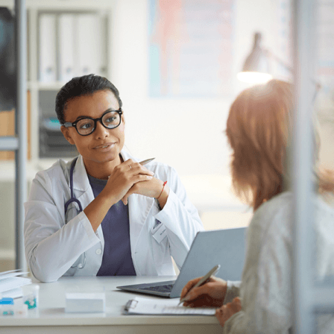 medical professional at desk, listening