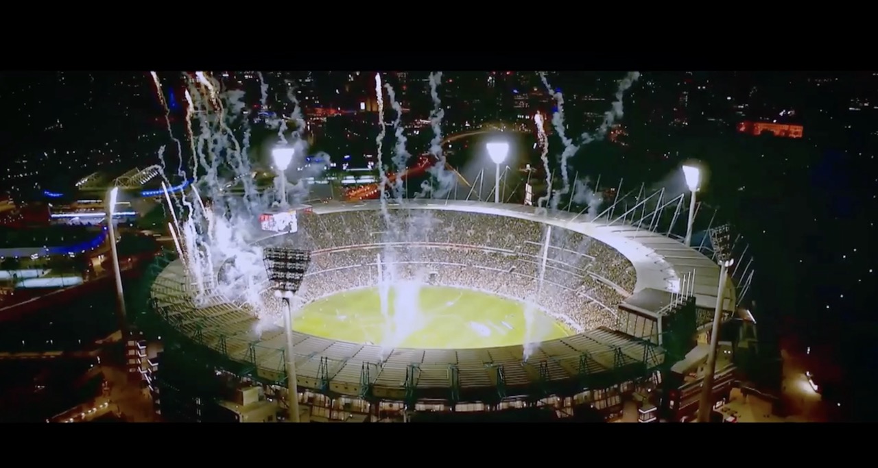 Aerial view of stadium lit up at night.